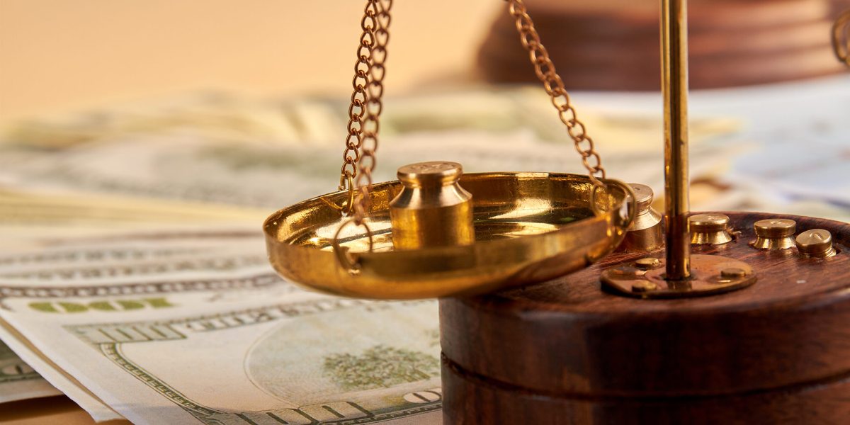 close-up-golden-scales-and-bunch-of-dollars-2024-09-15-04-43-42-utc