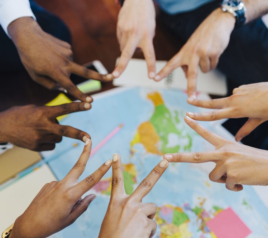 group-of-friends-making-hand-sign-above-world-map-2024-09-17-07-48-36-utc
