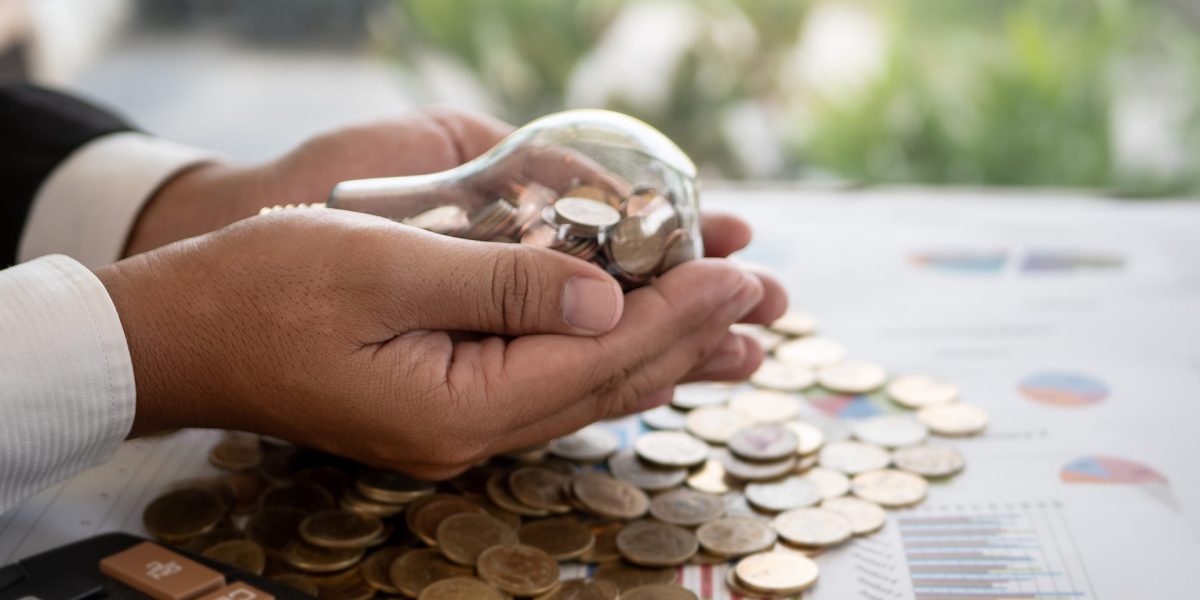 hands-of-businessman-holding-a-light-bulb-with-coi-2025-10-16-23-39-42-utc